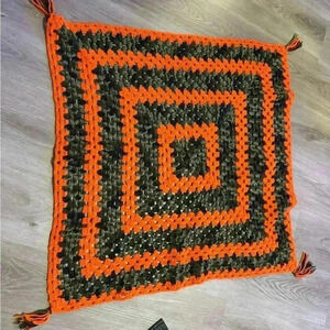 Handmade crocheted baby afghan blanket in orange & camo with tassels on corners